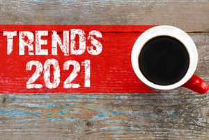 Trends 2021 / Cup of coffee with trends inscription on wooden background