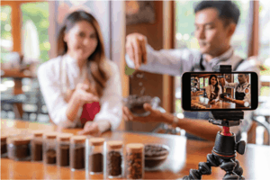 couple at table filming a cooking video