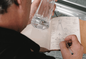 designing a bottle in a sketchbook