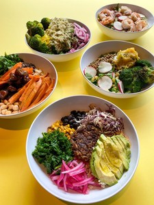 Recess Buckhead grain bowl options on a yellow table