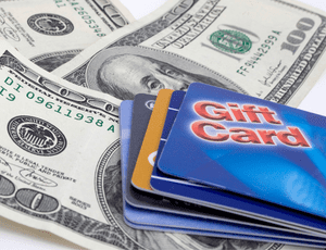 restaurant gift cards on top of 100 dollar bills